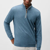 Broderick's Clothing Co. Johnnie-O Sully blue cotton-blend quarter-zip pullover worn by a smiling man
