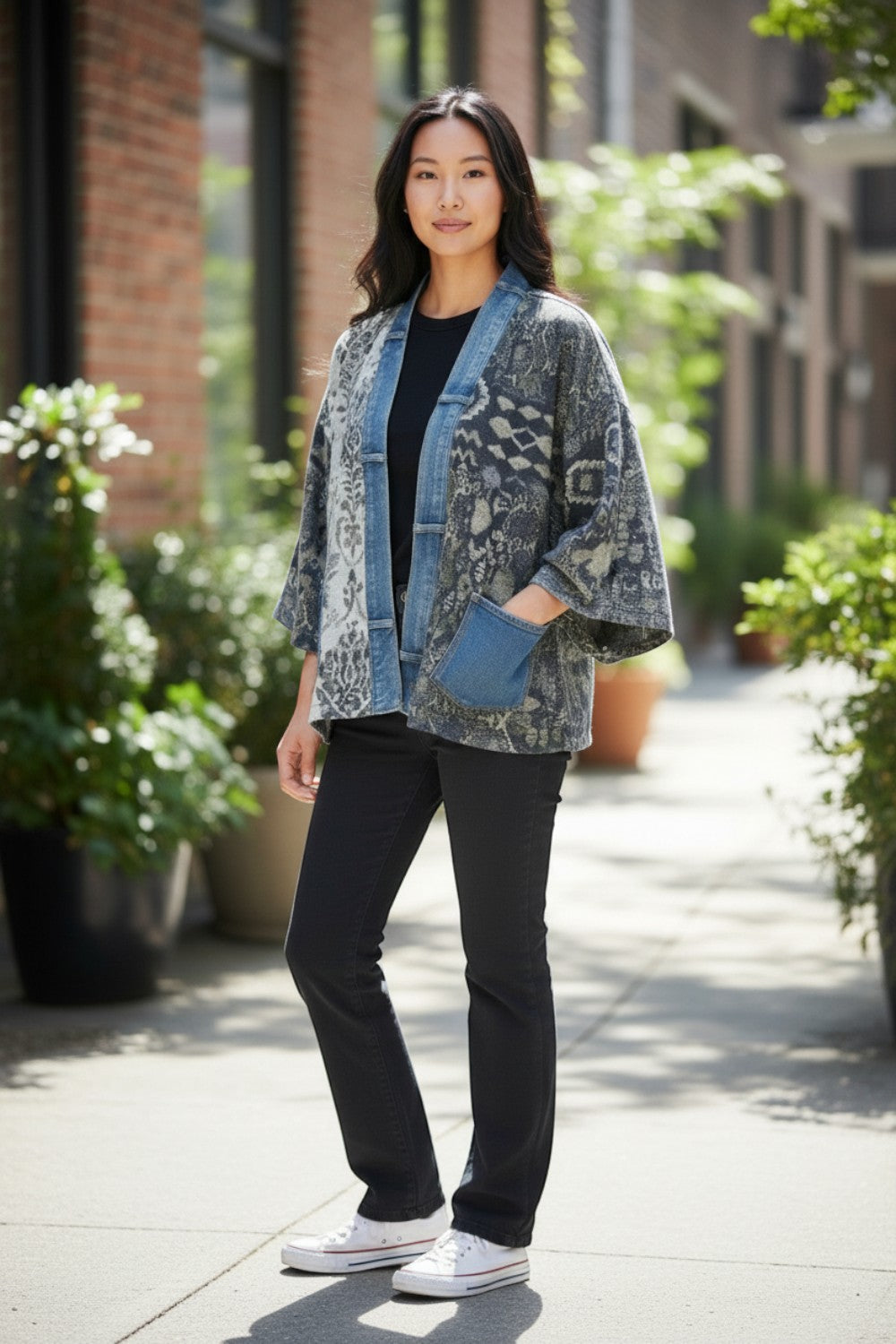 Model wearing a Broderick's Clothing Co. Shannon Passero Karol Cardigan with patterned fabric and denim trim details.