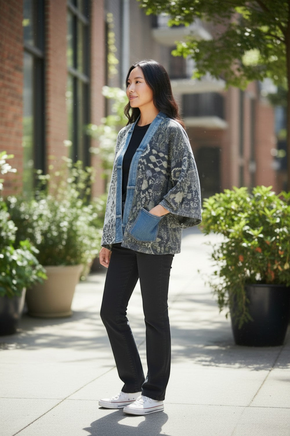 Model wearing Broderick's Clothing Co. Shannon Passero Karol Cardigan with patterned fabric and denim trim pockets.