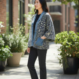 Model wearing Broderick's Clothing Co. Shannon Passero Karol Cardigan with patterned fabric and denim trim pockets.
