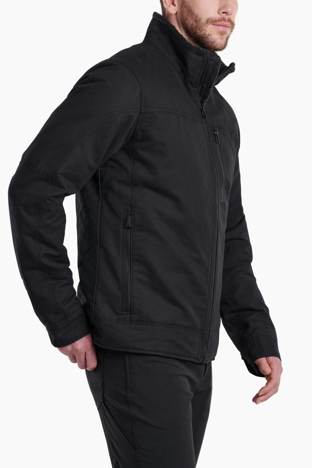 Broderick's Clothing Co. KÜHL BURR black insulated jacket with berber collar and rugged cotton exterior on a model