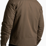 Back view of a man wearing a brown KÜHL BURR Insulated Jacket from Broderick's Clothing Co. with a berber collar.