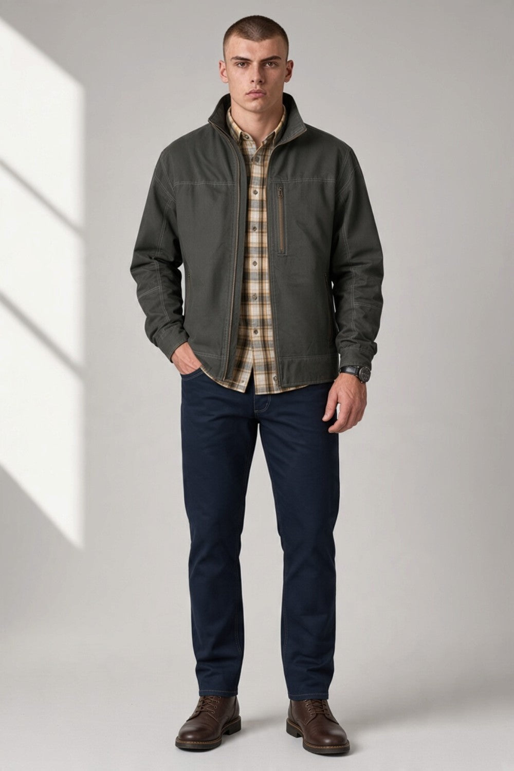 Broderick's Clothing Co. KÜHL BURR jacket in dark grey canvas with a zip front, worn by a male model.