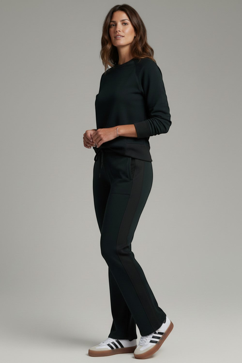 Broderick's Clothing Co. KÜHL Kozy black fleece-backed knit pants with rib paneling worn by a woman