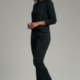 Broderick's Clothing Co. KÜHL Kozy black fleece-backed knit pants with rib paneling worn by a woman