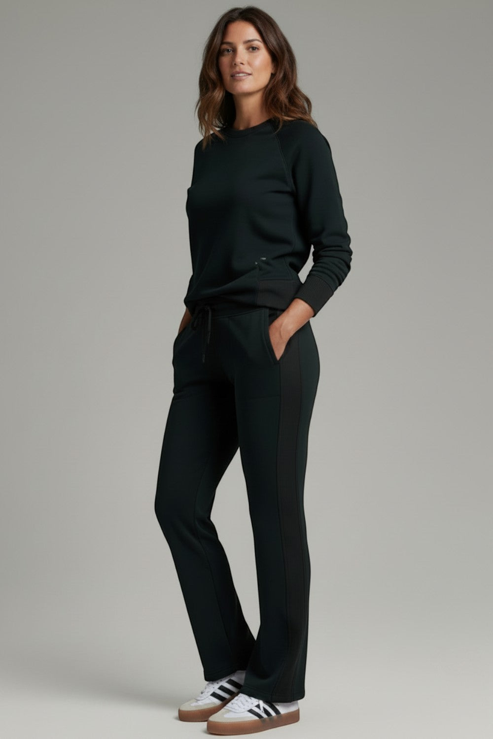 Broderick's Clothing Co. KÜHL Kozy black fleece-backed knit pants with rib paneling worn by a woman
