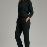 Broderick's Clothing Co. KÜHL Kozy black fleece-backed knit pants with rib paneling worn by a woman