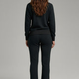 Broderick's Clothing Co. KÜHL Kozy black fleece-backed knit pants worn by a woman from a rear view