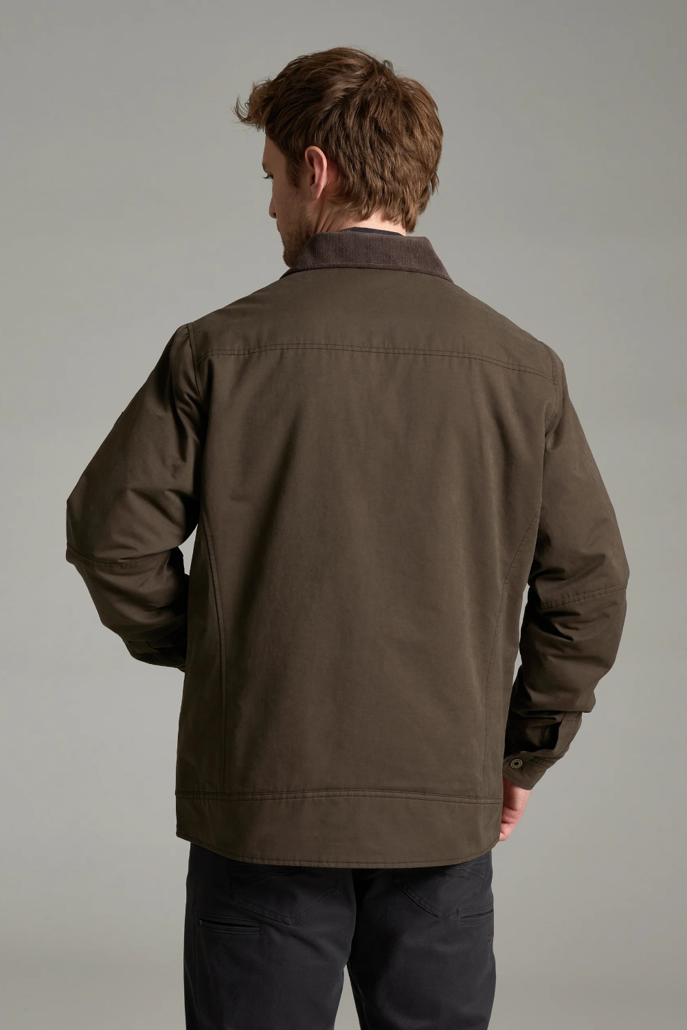 Broderick's Clothing Co. KÜHL MAVERICK jacket in olive canvas with fleece lining, shown from the back on a model.