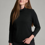 Broderick's Clothing Co. KÜHL Remi black turtleneck pullover with crinkle rib texture worn by a smiling woman
