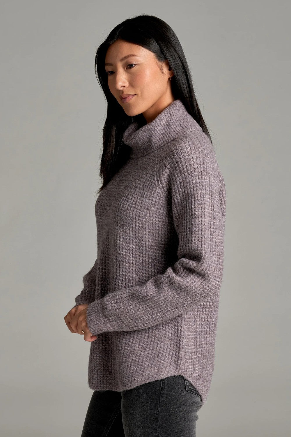 Broderick's Clothing Co. KÜHL Sienna sweater in heathered mauve with a ribbed cowl neck and curved hem on a model.