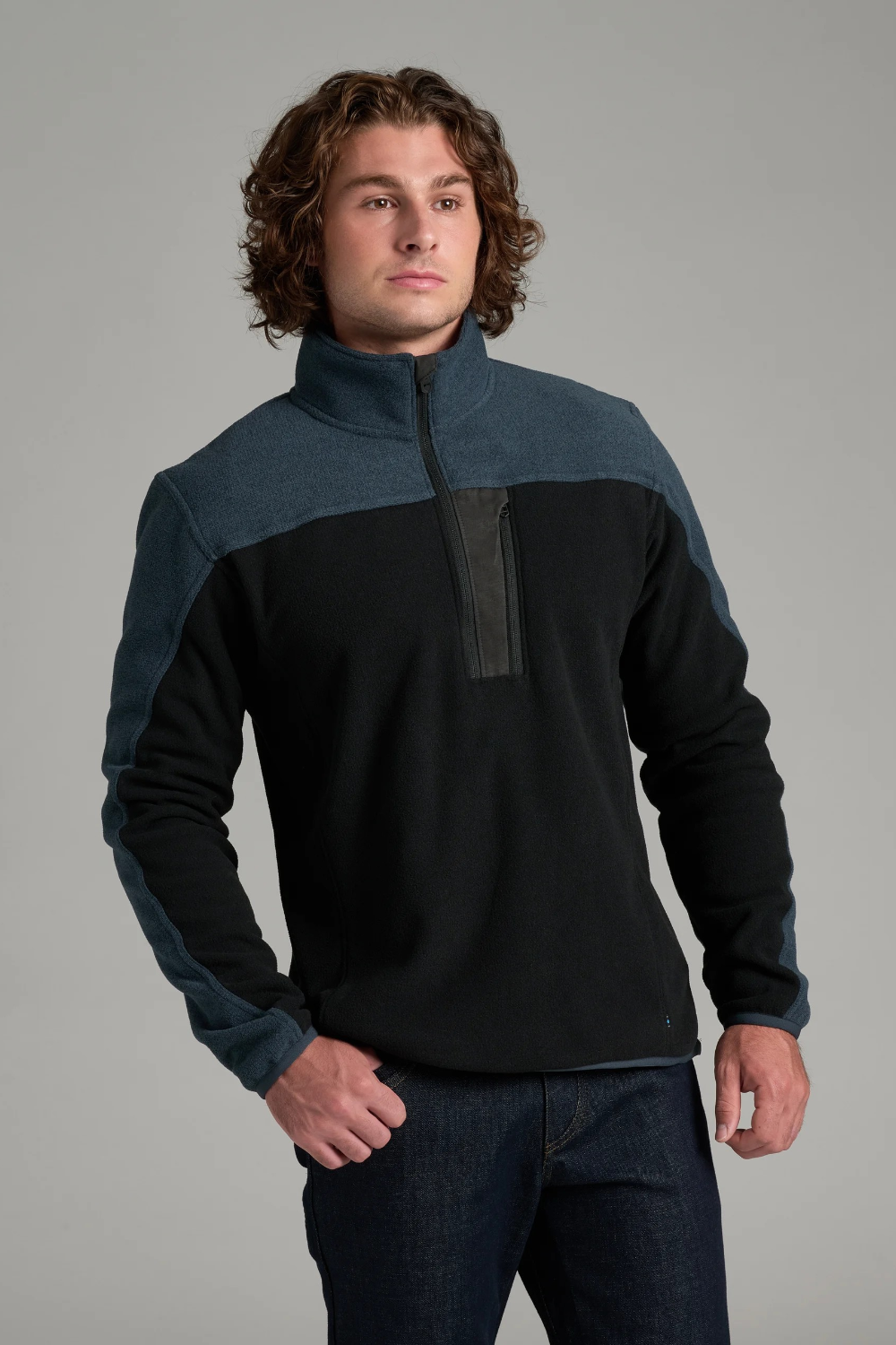 Broderick's Clothing Co. KÜHL SKORCHR fleece quarter-zip sweater in black and blue with a zippered chest pocket.