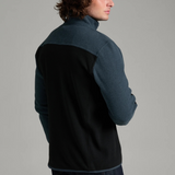Broderick's Clothing Co. KÜHL SKORCHR fleece quarter-zip sweater in blue and black worn by a man, back view.