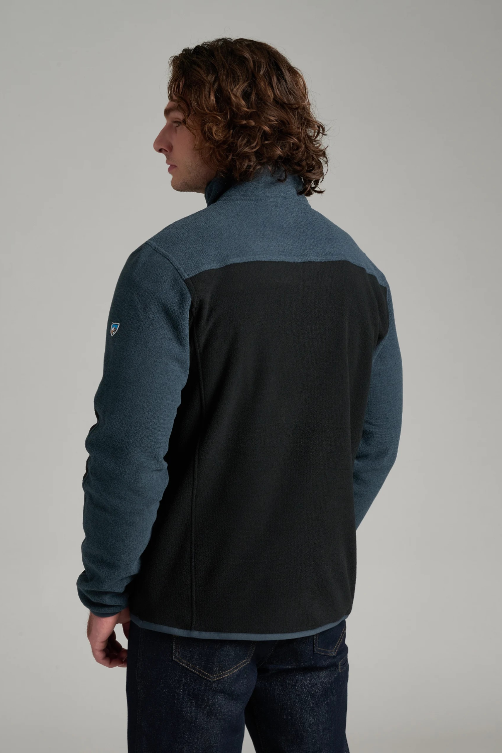 Broderick's Clothing Co. KÜHL SKORCHR fleece 1/4 zip sweater in blue and black, back view on a male model.