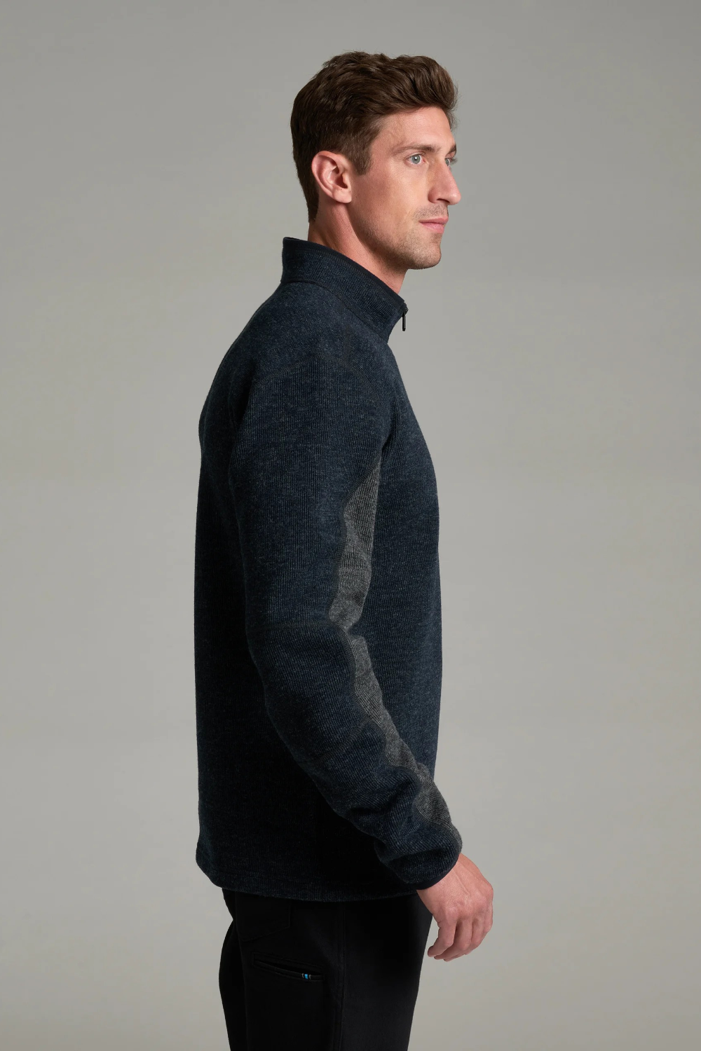Broderick's Clothing Co. KÜHL Thor 1/4 zip sweater in dark navy wool blend with grey underarm gussets on a model