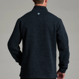 Back view of a man wearing a dark charcoal KÜHL Thor 1/4 Zip Sweater from Broderick's Clothing Co.