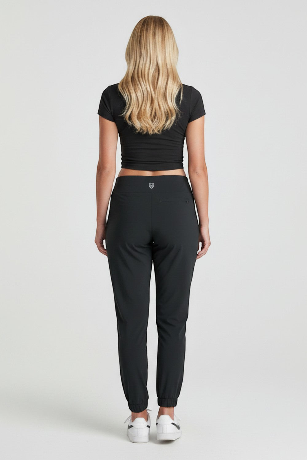 Broderick's Clothing Co. KÜHL Vantage black lined jogger pants worn by a woman, back view showing elastic cuffs.