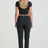 Broderick's Clothing Co. KÜHL Vantage black lined jogger pants worn by a woman, back view showing elastic cuffs.
