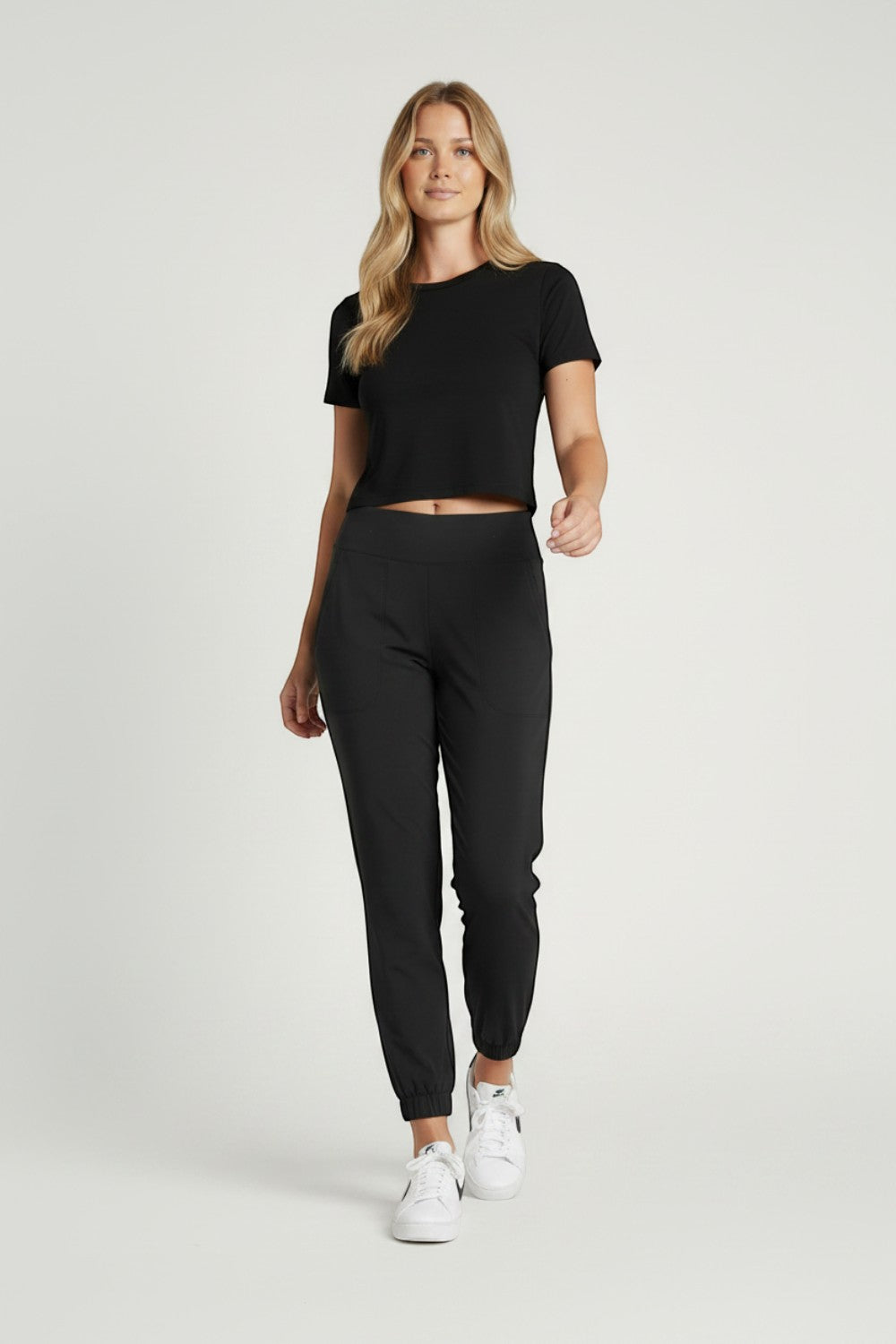Model wearing Broderick's Clothing Co. KÜHL Vantage black lined jogger pants with a wide elastic waistband.