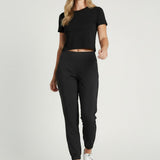 Model wearing Broderick's Clothing Co. KÜHL Vantage black lined jogger pants with a wide elastic waistband.