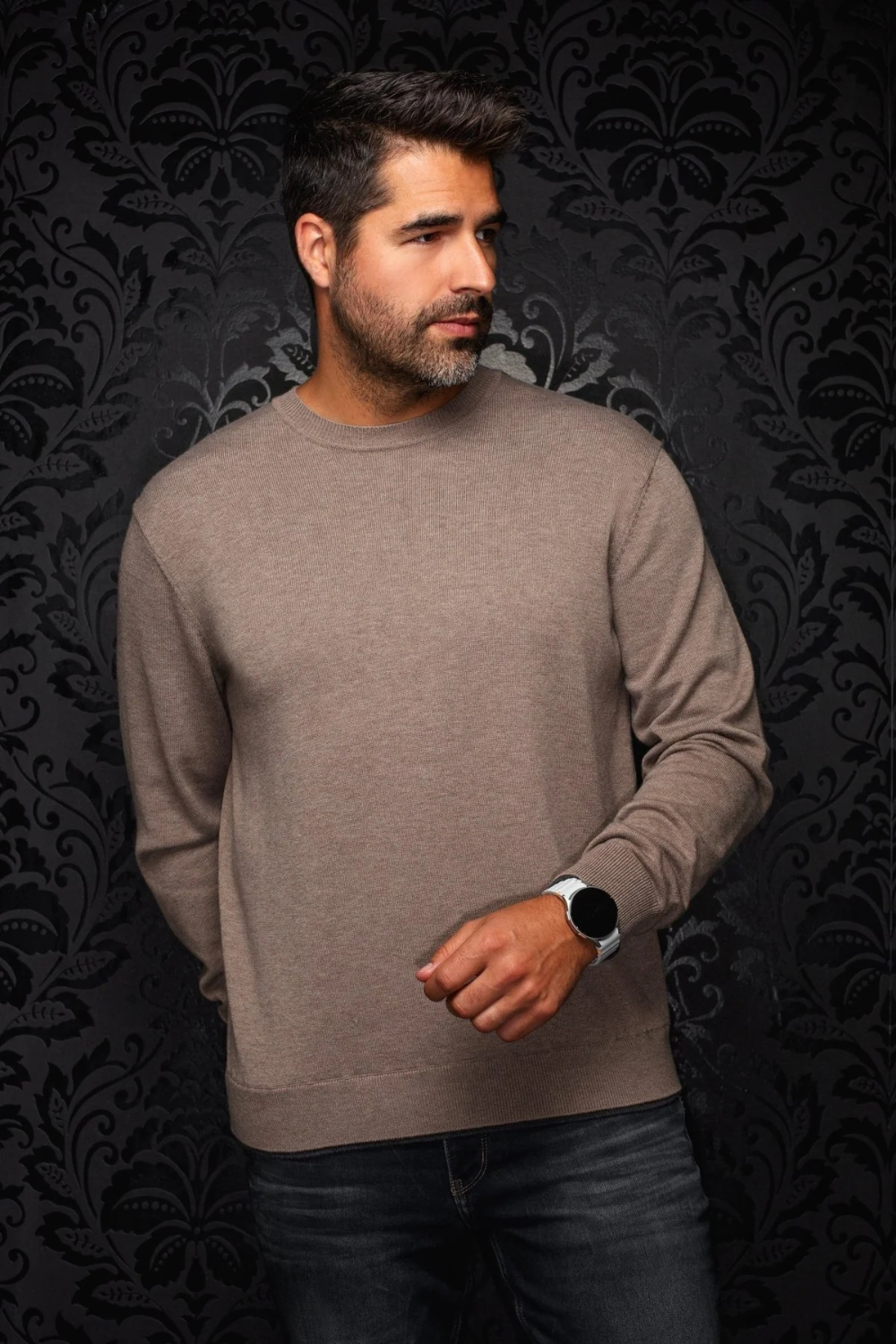 Broderick's Clothing Co. Au Noir LACAUNE beige cashmere crew neck sweater worn by a man against a damask background