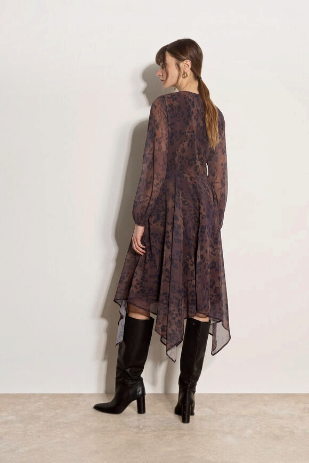 Broderick's Clothing Co. apricot leopard print chiffon midi dress with hanky hem and blouson sleeves, back view.