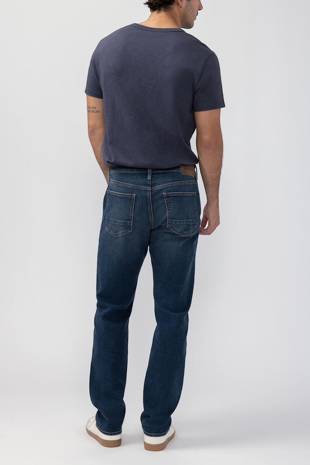 Broderick's Clothing Co. Silver Jeans Co. Machray straight leg jeans in dark blue denim worn by a man from behind