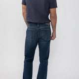 Broderick's Clothing Co. Silver Jeans Co. Machray straight leg jeans in dark blue denim worn by a man from behind