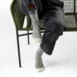 Broderick's Clothing Co. Smartwool merino wool crew socks with grey and white pin stripes worn by a seated person