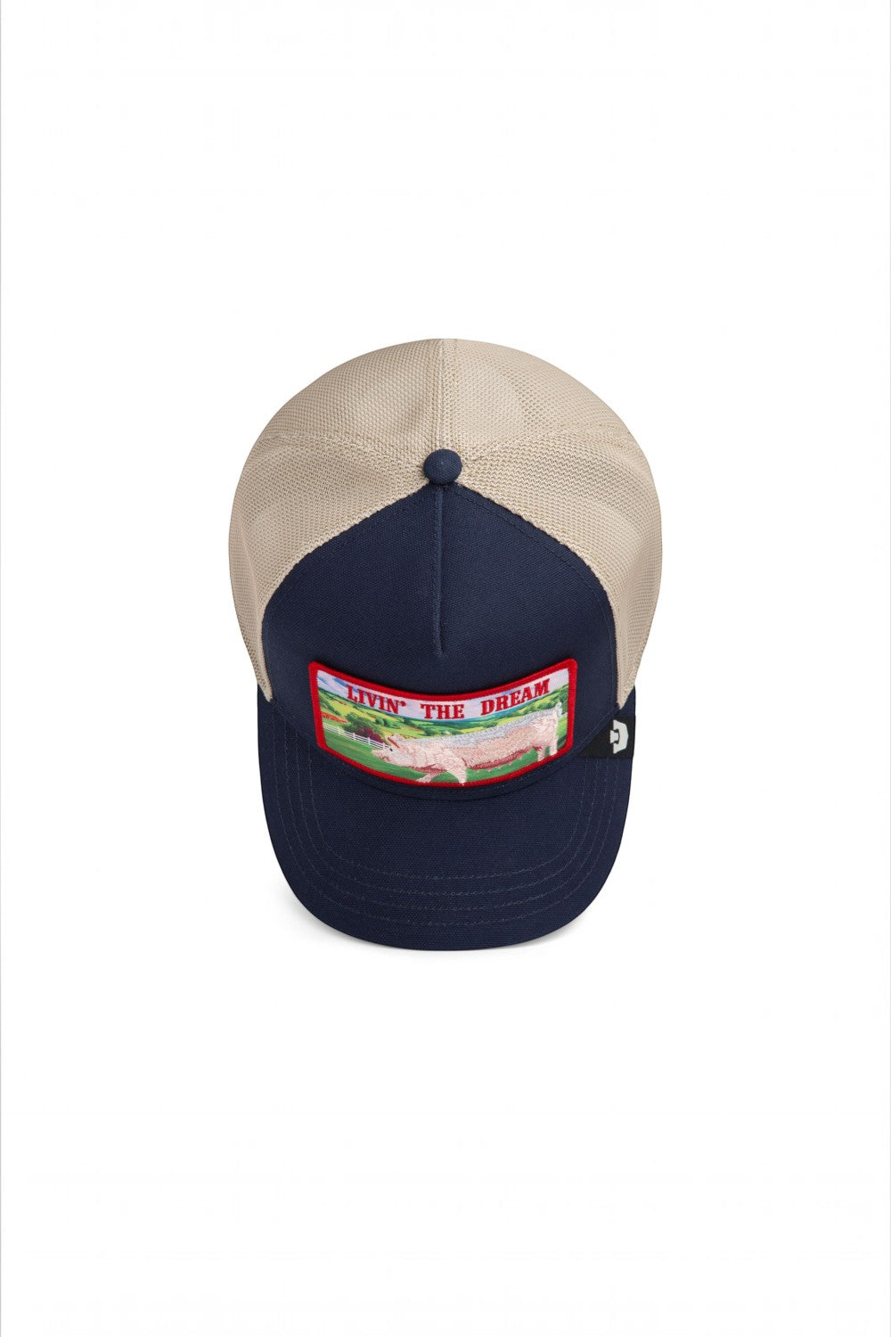 Broderick's Clothing Co. navy and beige trucker hat featuring a Livin' The Dream pig patch on the front panel.