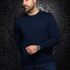 Broderick's Clothing Co. navy blue Au Noir LACAUNE cashmere crew neck sweater worn by a man against damask wallpaper