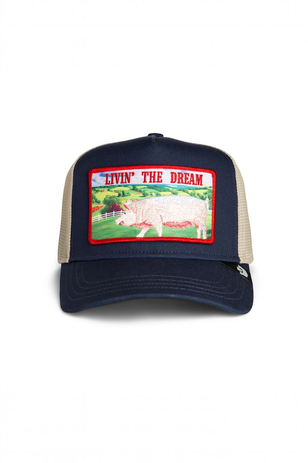 Broderick's Clothing Co. navy trucker hat with a Livin' The Dream pig patch and beige mesh back