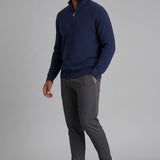 Broderick's Clothing Co. navy blue textured cotton quarter-zip sweater worn by a man with grey trousers and sneakers.