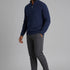 Broderick's Clothing Co. navy blue textured cotton quarter-zip sweater worn by a man with grey trousers and sneakers.