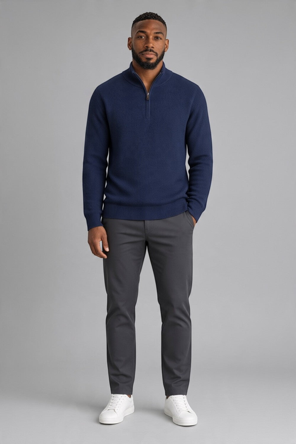 Broderick's Clothing Co. navy blue cotton quarter-zip sweater with a textured knit worn by a man with grey trousers.