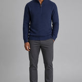 Broderick's Clothing Co. navy blue cotton quarter-zip sweater with a textured knit worn by a man with grey trousers.