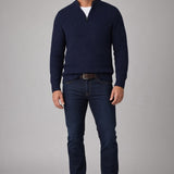 Broderick's Clothing Co. navy blue merino wool blend quarter zip sweater worn by a model with dark jeans and boots