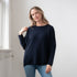 Broderick's Clothing Co. Sara crew neck sweater in navy blue rib knit with dolman sleeves worn by a woman.