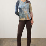Broderick's Clothing Co. 3/4 sleeve notch neck top featuring a multi-colored geometric pattern worn with brown pants.