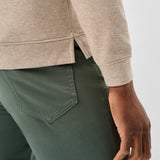 Broderick's Clothing Co. oatmeal heathered cotton-blend hoodie with side hem vents paired with olive green trousers.