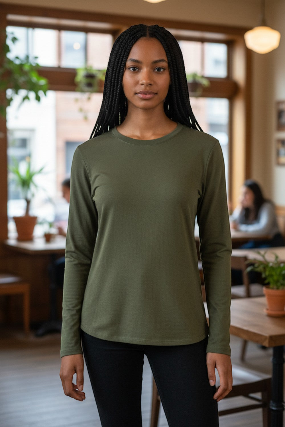 Model wearing a Broderick's Clothing Co. Shannon Passero Zoya olive green long sleeve top with a soft stretch fit.