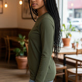 Model wearing a Broderick's Clothing Co. Shannon Passero Zoya olive green long-sleeve top with 4-way stretch fabric.
