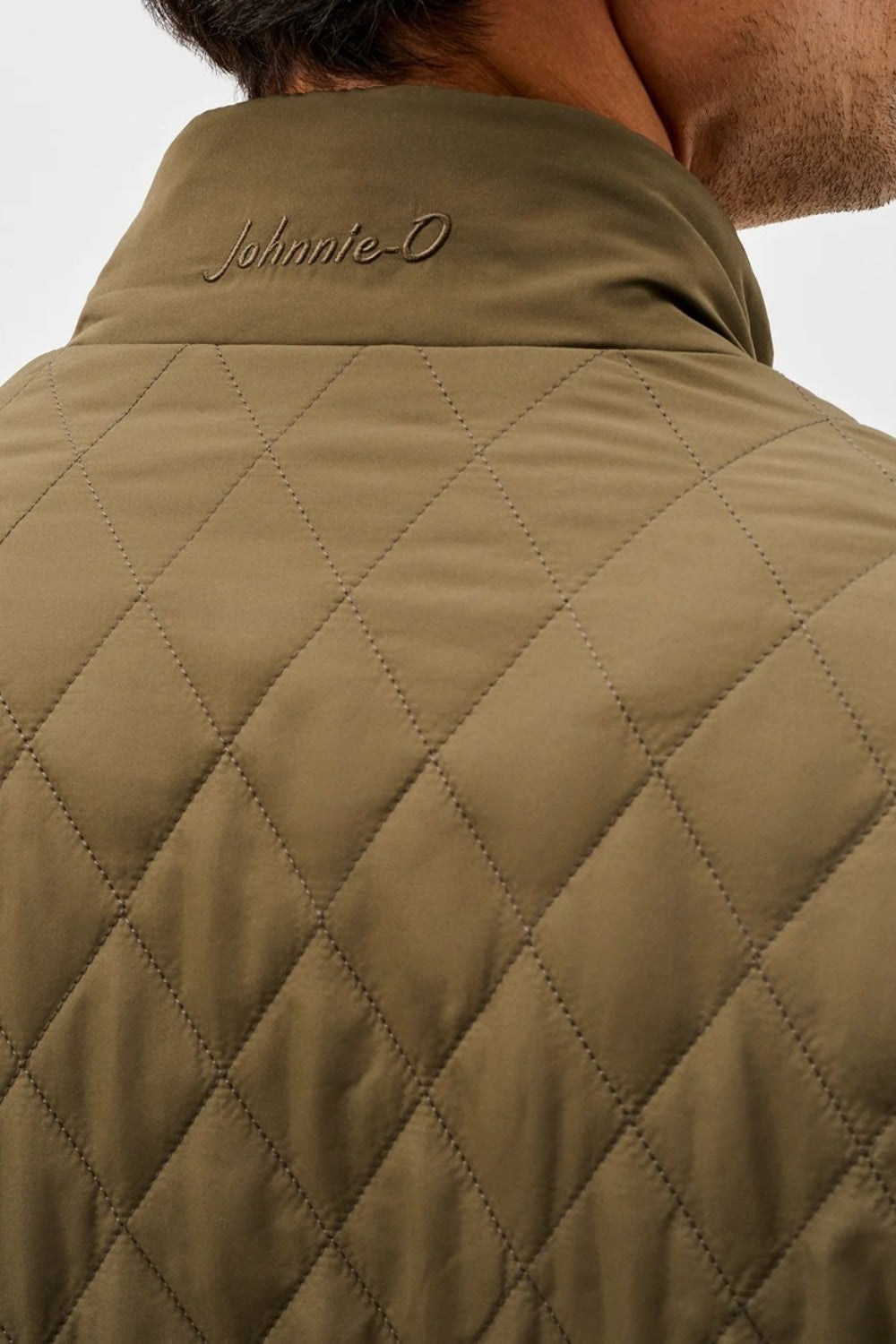 Broderick's Clothing Co. olive green diamond-quilted jacket with Johnnie-O logo embroidery on the collar