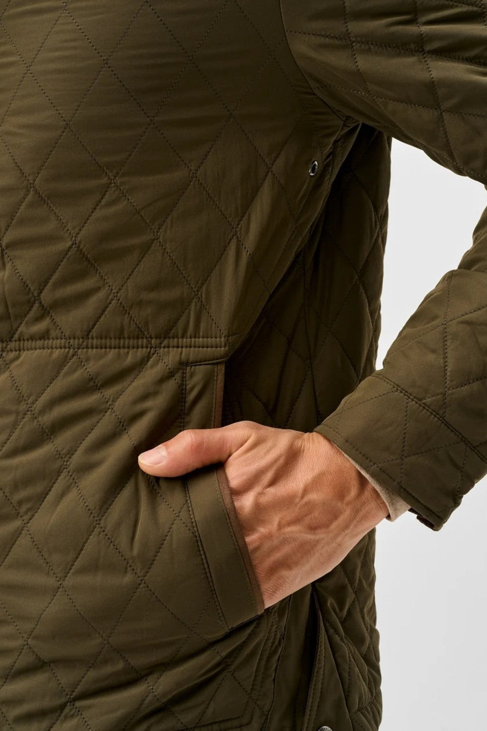 Broderick's Clothing Co. olive green diamond-quilted jacket with magnetic pocket detail on a man