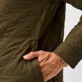 Broderick's Clothing Co. olive green diamond-quilted jacket with magnetic pocket detail on a man
