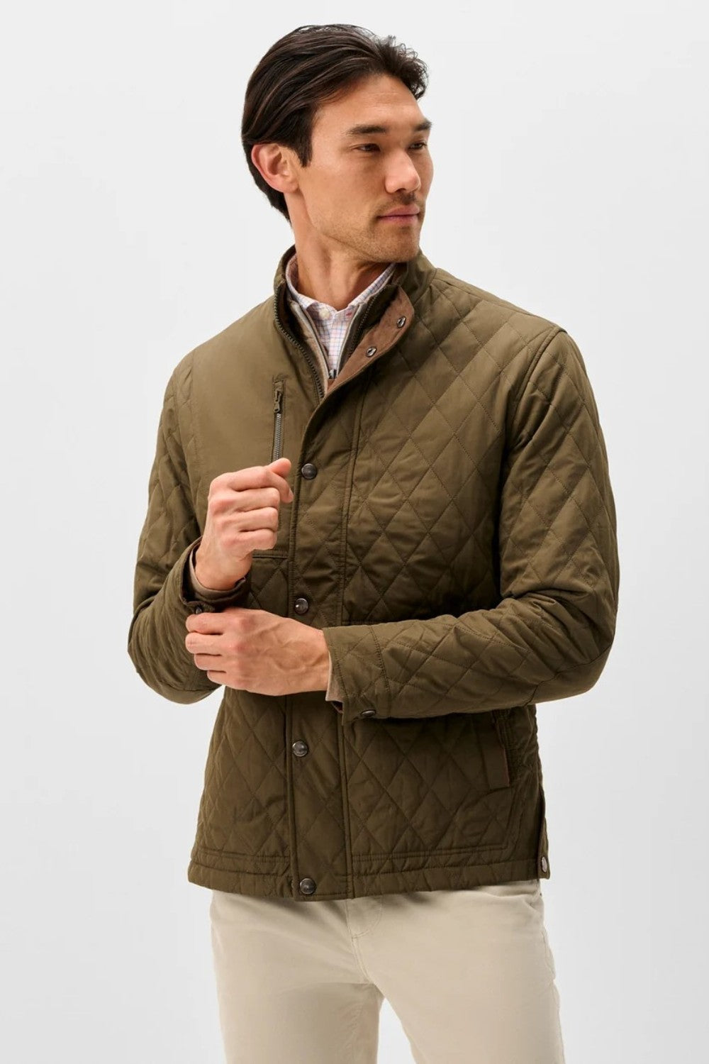 Broderick's Clothing Co. olive green diamond-quilted snap jacket with suede trim worn by a man on a white background.