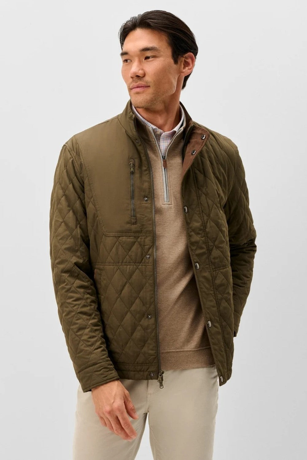 Broderick's Clothing Co. olive green diamond-quilted snap jacket with performance suede details on a male model.