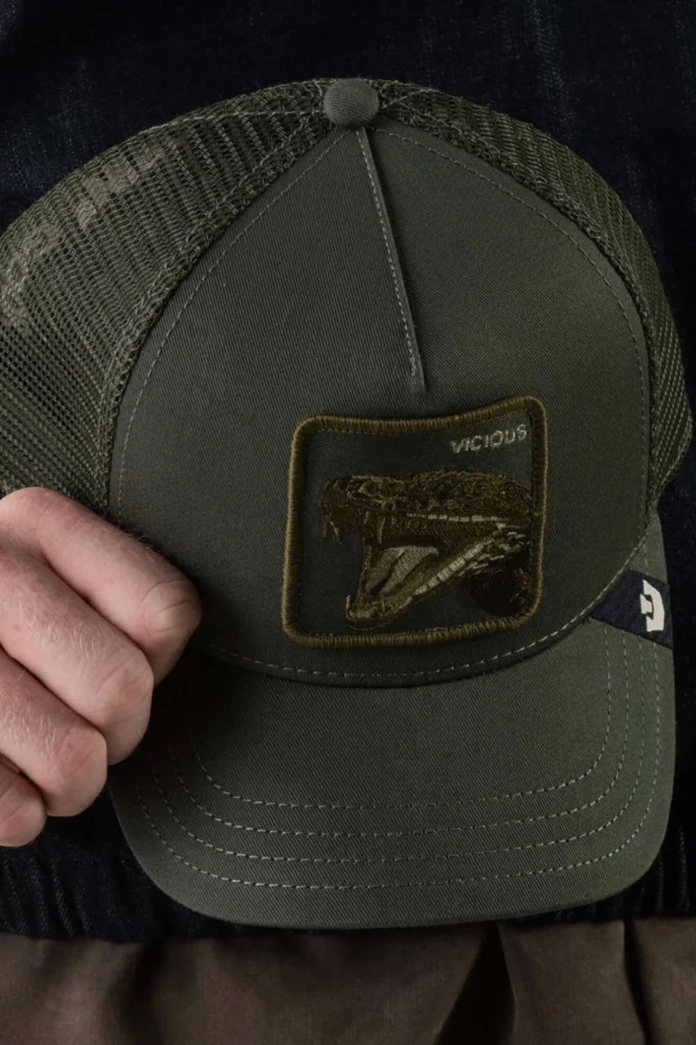Broderick's Clothing Co. olive green Goorin Bros. trucker hat with a Vicious snake patch and breathable mesh back