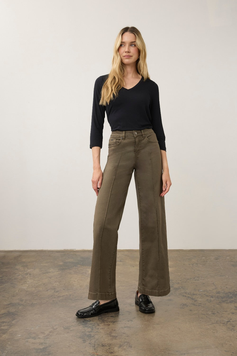 Broderick's Clothing Co. FDJ Olivia wide leg pants in olive green euro twill with pintuck detailing on a model.