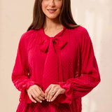 Broderick's Clothing Co. red crinkle chiffon blouse with polka dot texture, bow-tie neck, and ruffled long sleeves.